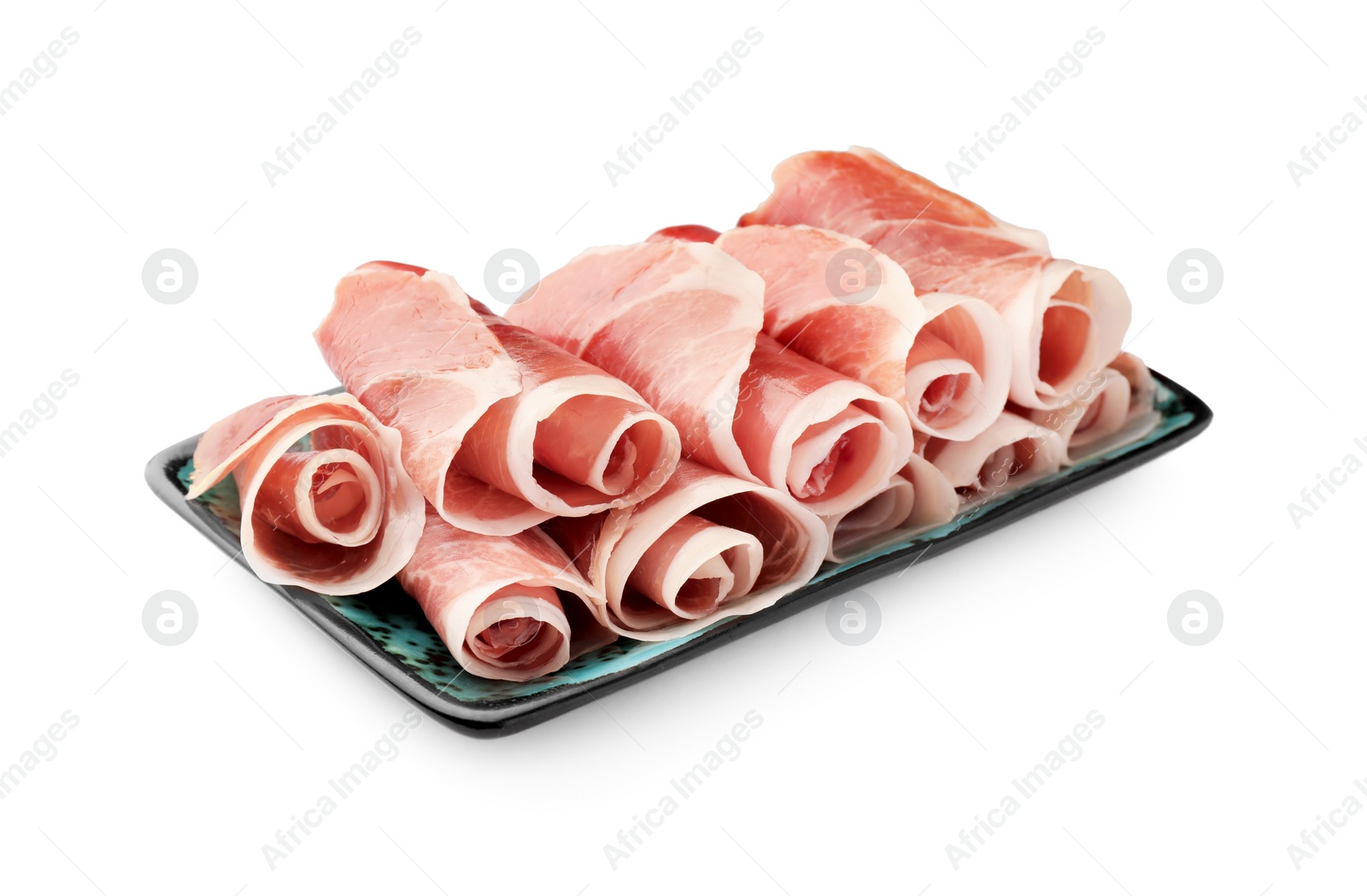 Photo of Plate with rolled slices of delicious jamon isolated on white