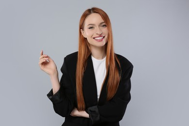 Photo of Portrait of beautiful young woman on light gray background