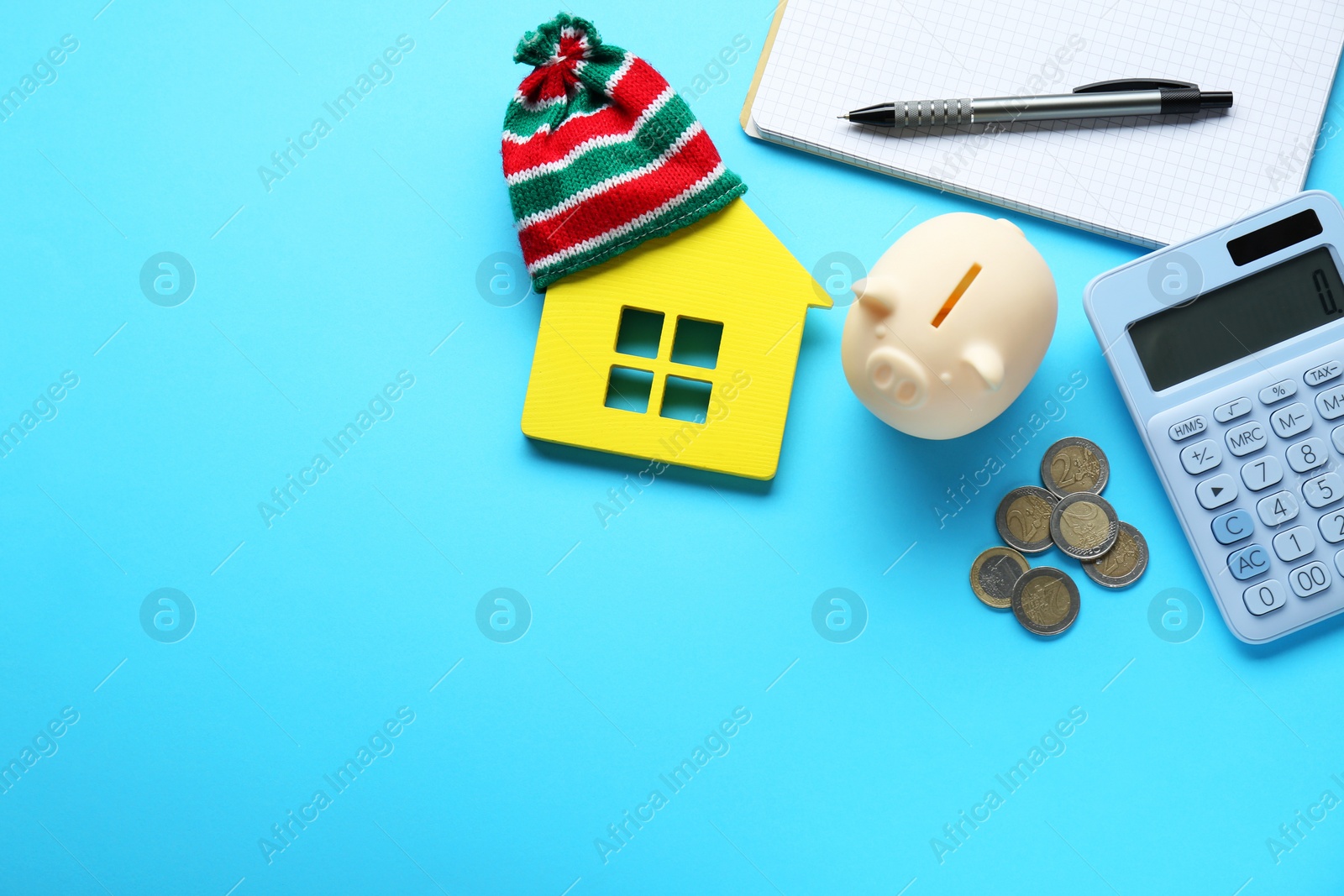 Photo of Flat lay composition with piggy bank and calculator on light blue background, space for text. Paying bills concept