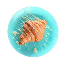 Plate of fresh croissant with condensed milk on white background, top view. French pastry