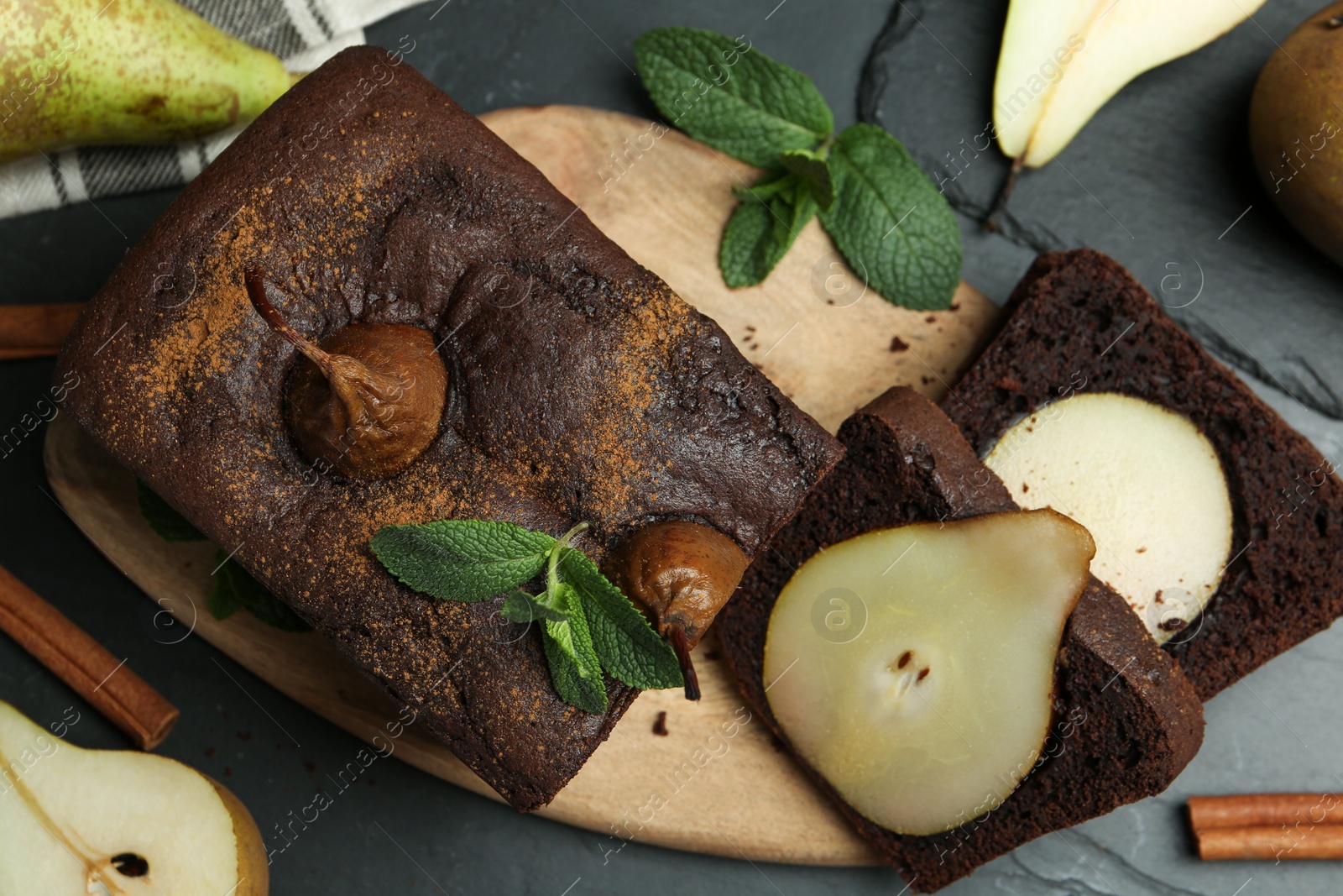 Photo of Flat lay composition with tasty pear bread on black table. Homemade cake