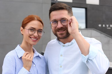 Portrait of happy couple in glasses outdoors