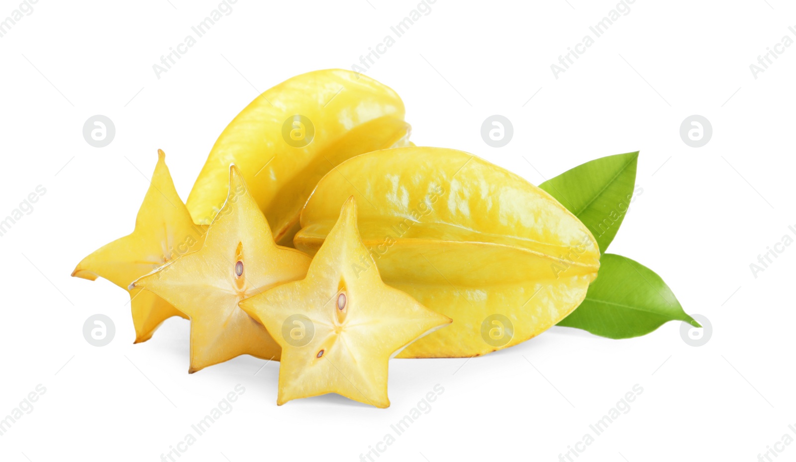 Photo of Cut and whole carambolas with green leaves on white background