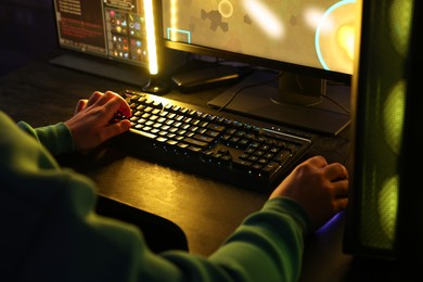 Man playing video games on computer indoors, closeup