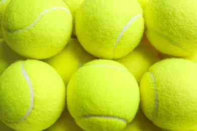 Tennis balls as background, closeup. Sports equipment