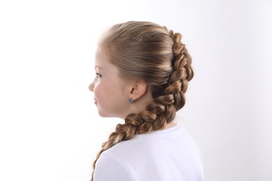 Little girl with braided hair on white background