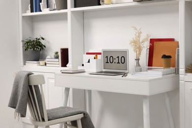 Photo of Cozy workspace with laptop on wooden desk at home