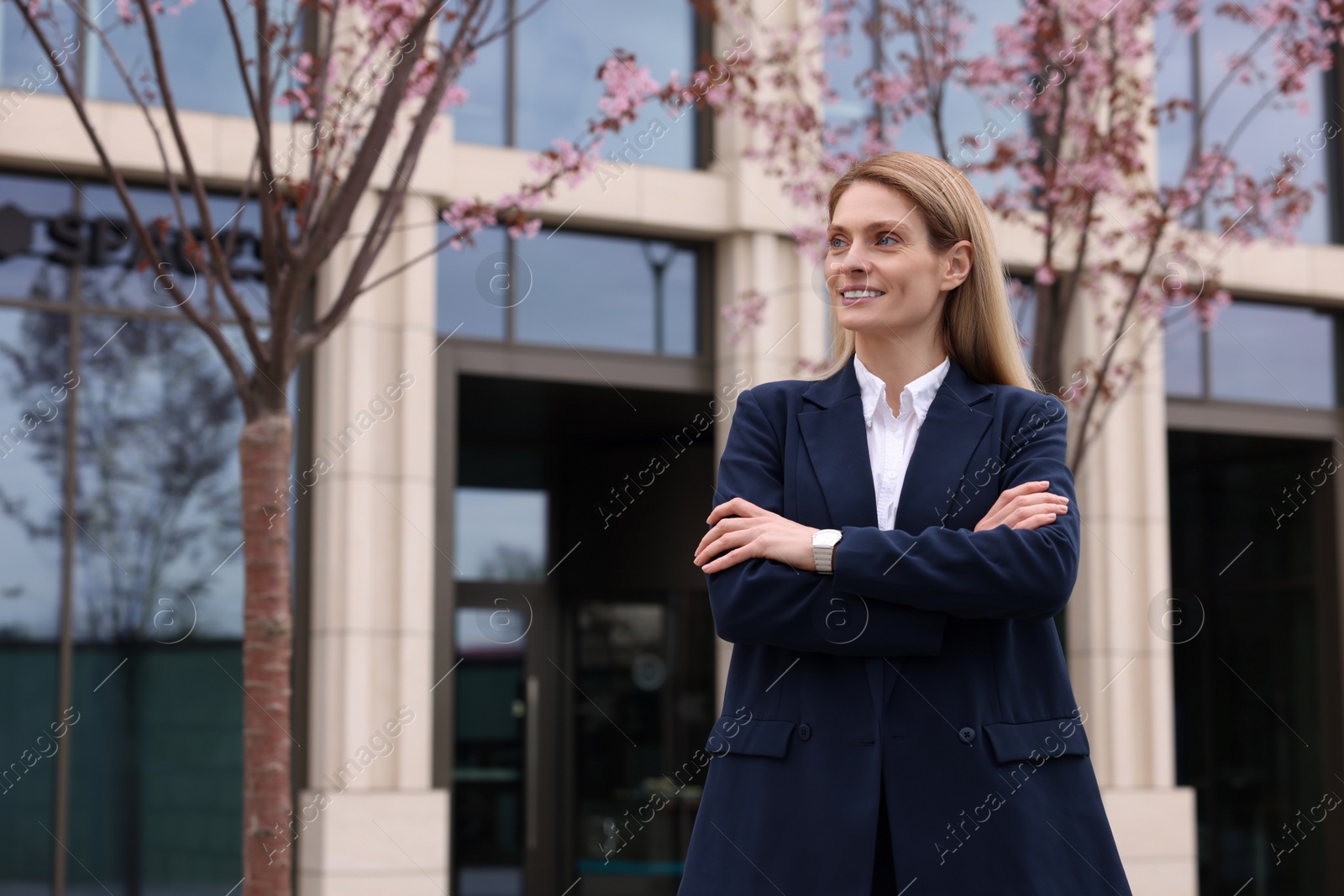 Photo of Happy real estate agent outdoors. Space for text