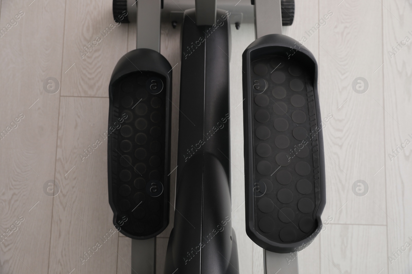 Photo of Modern elliptical machine cross trainer on floor, top view