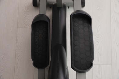 Photo of Modern elliptical machine cross trainer on floor, top view