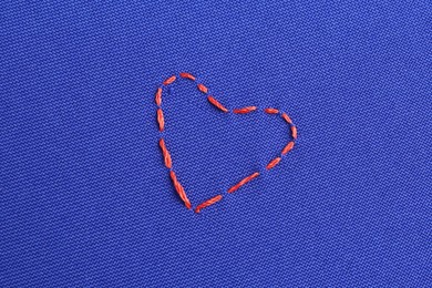 Embroidered heart on blue cloth, top view