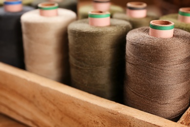 Photo of Container with set of color sewing threads, closeup
