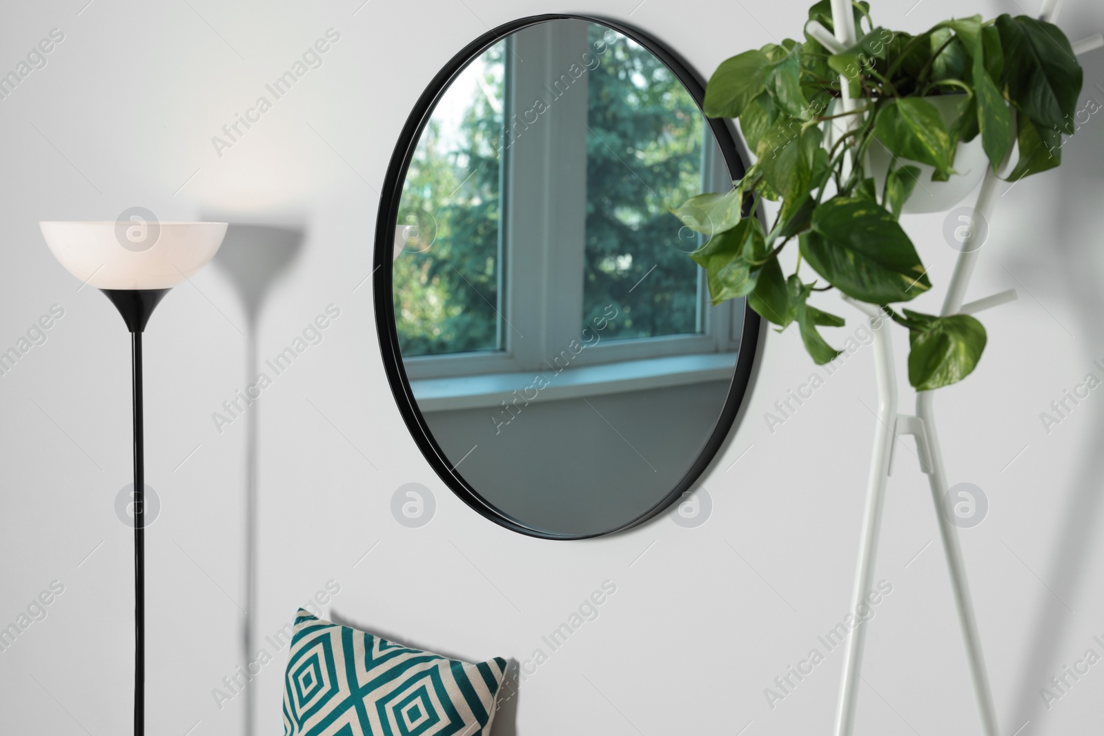 Photo of Stylish round mirror on white wall in room