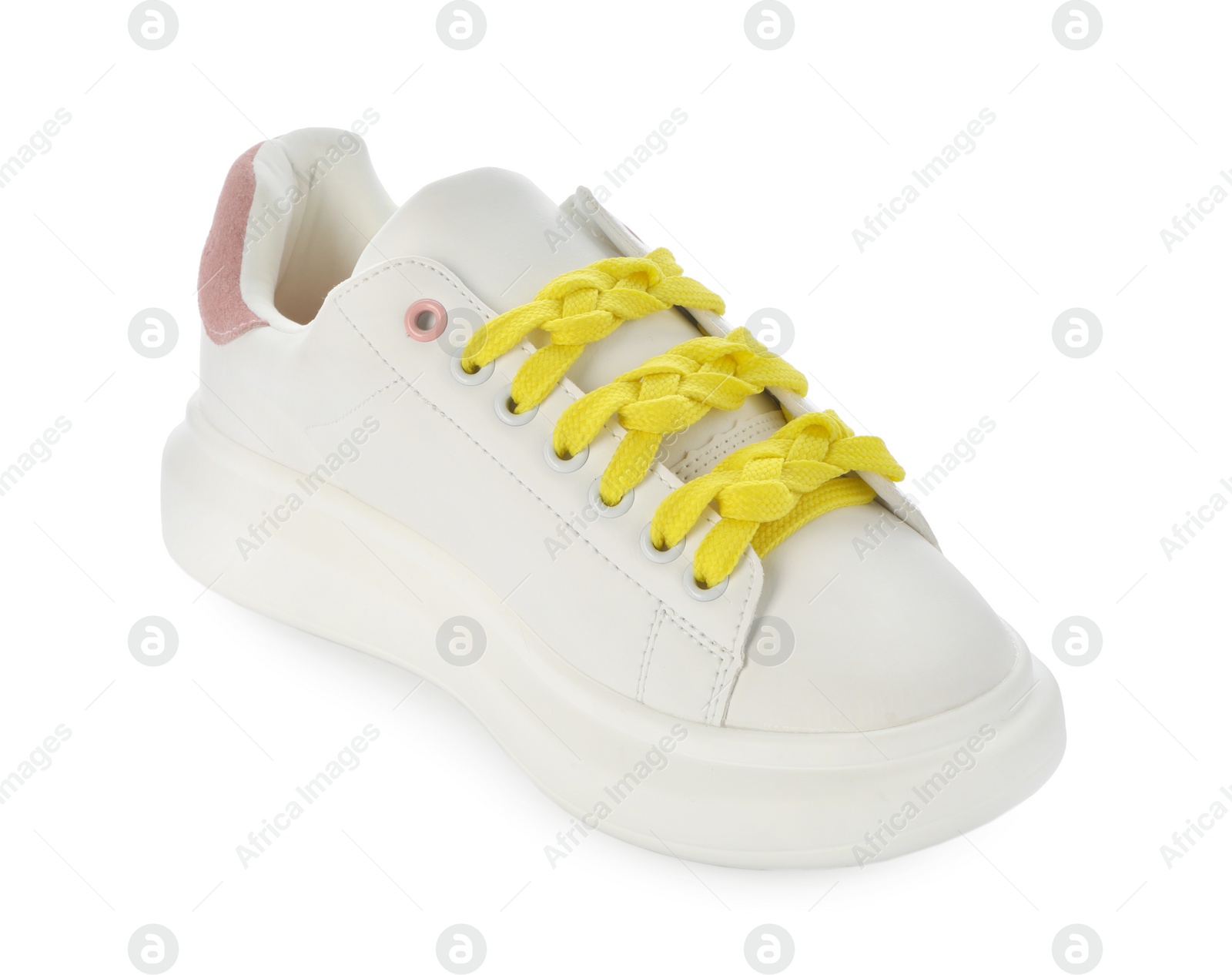 Photo of Stylish sneaker with yellow shoelaces on white background