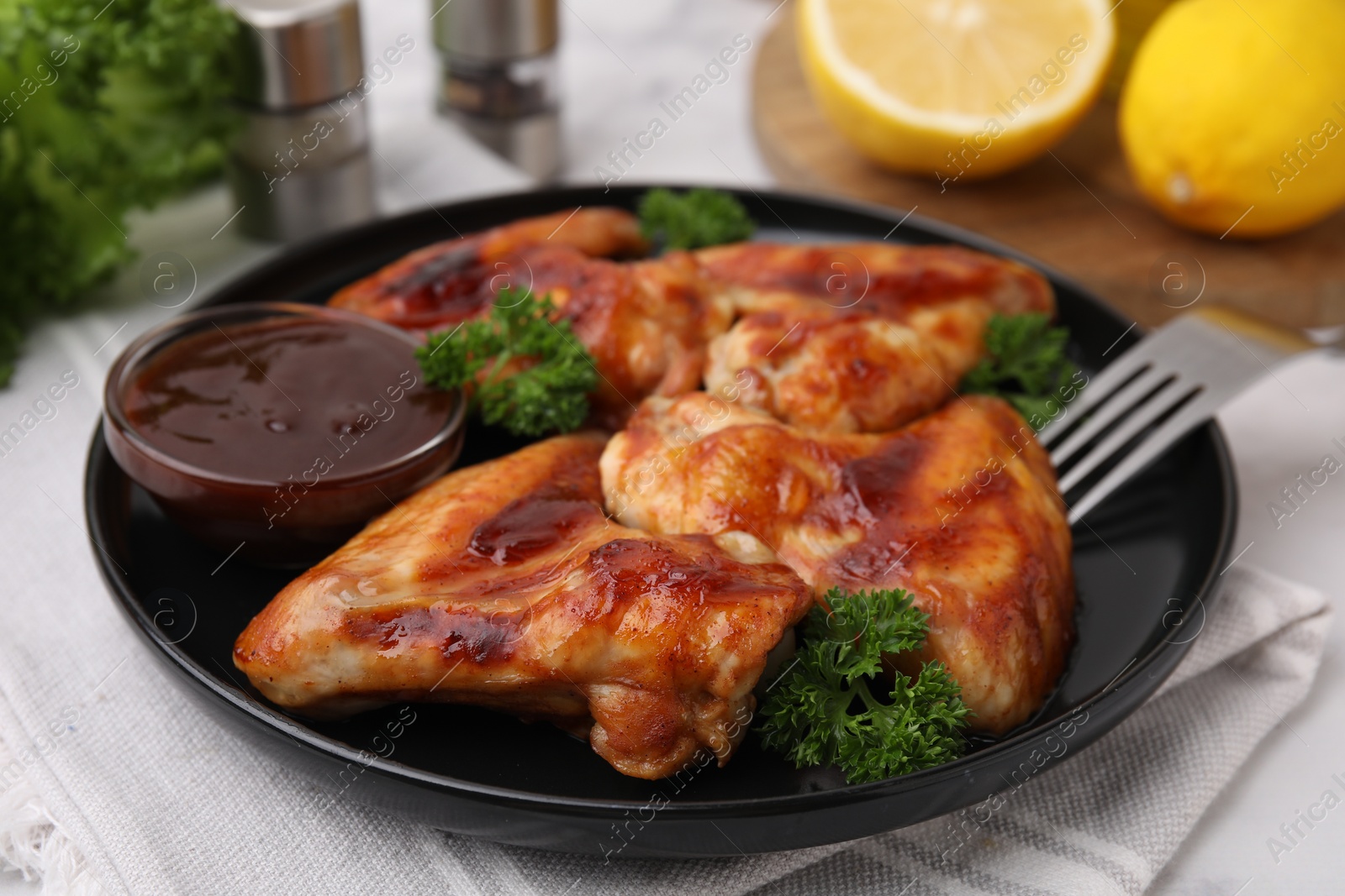 Photo of Fresh marinade and chicken wings on table, closeup