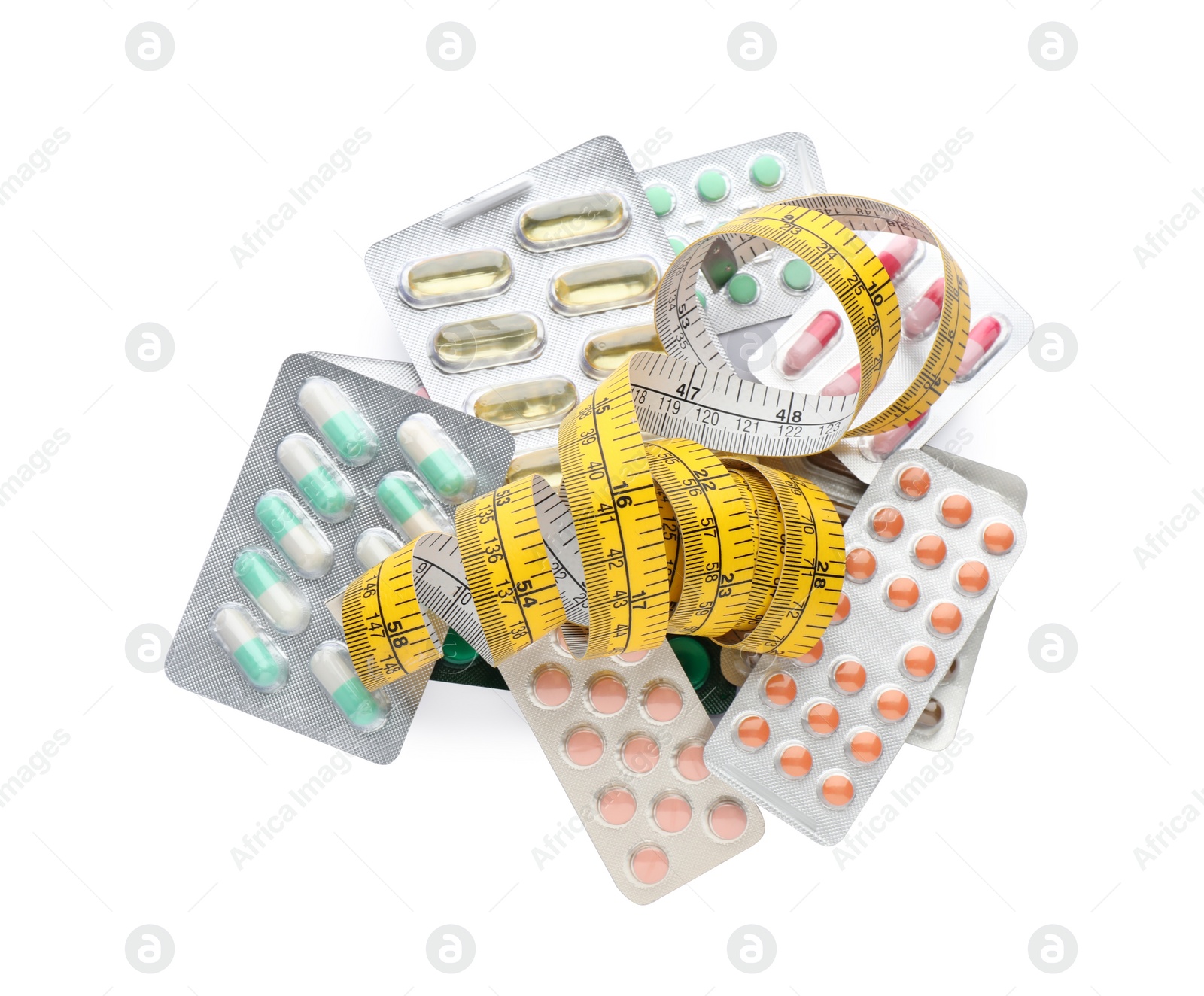 Photo of Many different weight loss pills and measuring tape on white background, top view