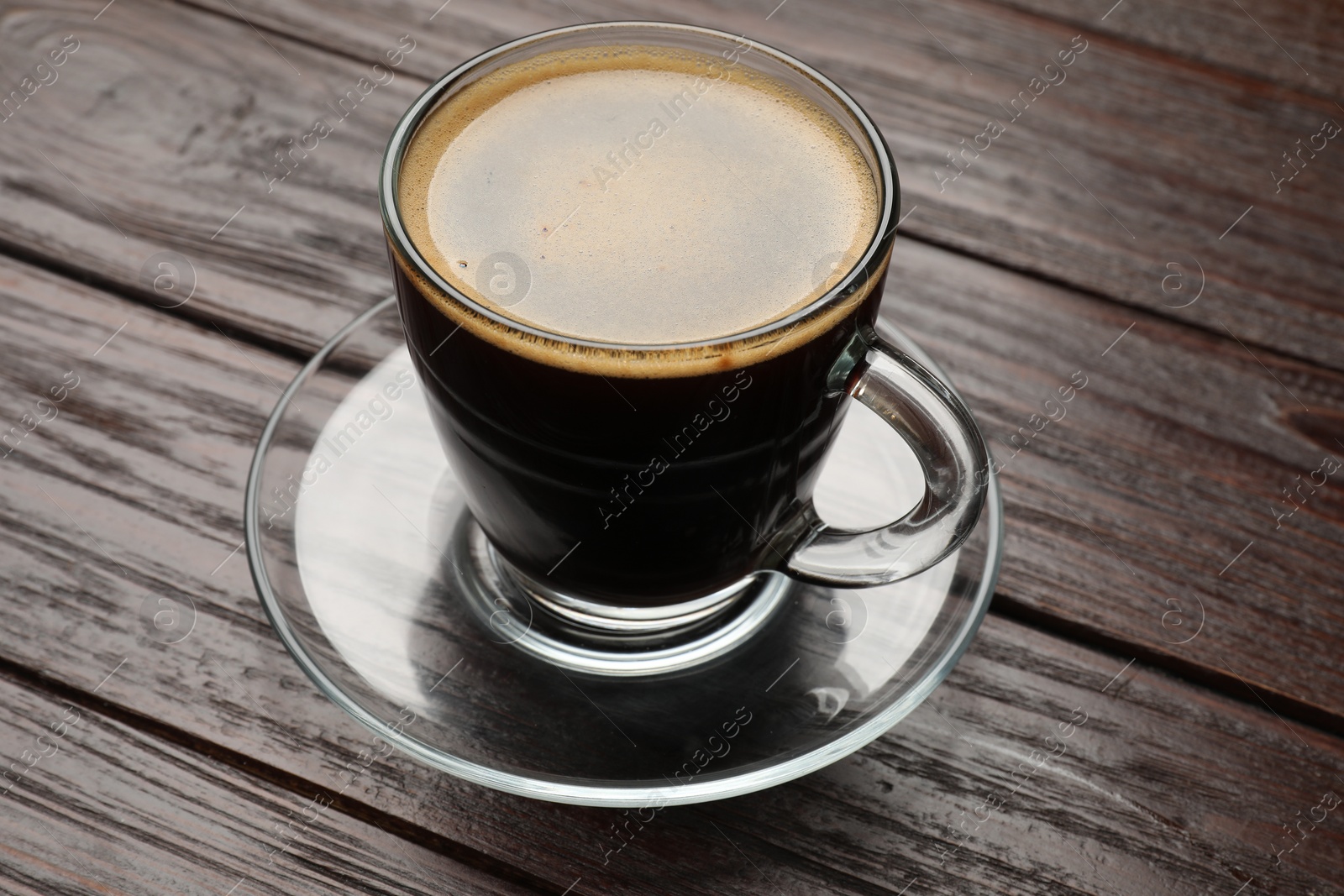 Photo of Cup of aromatic coffee on wooden table, closeup