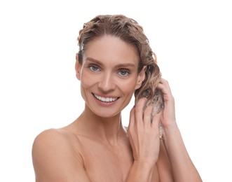 Beautiful happy woman washing hair on white background