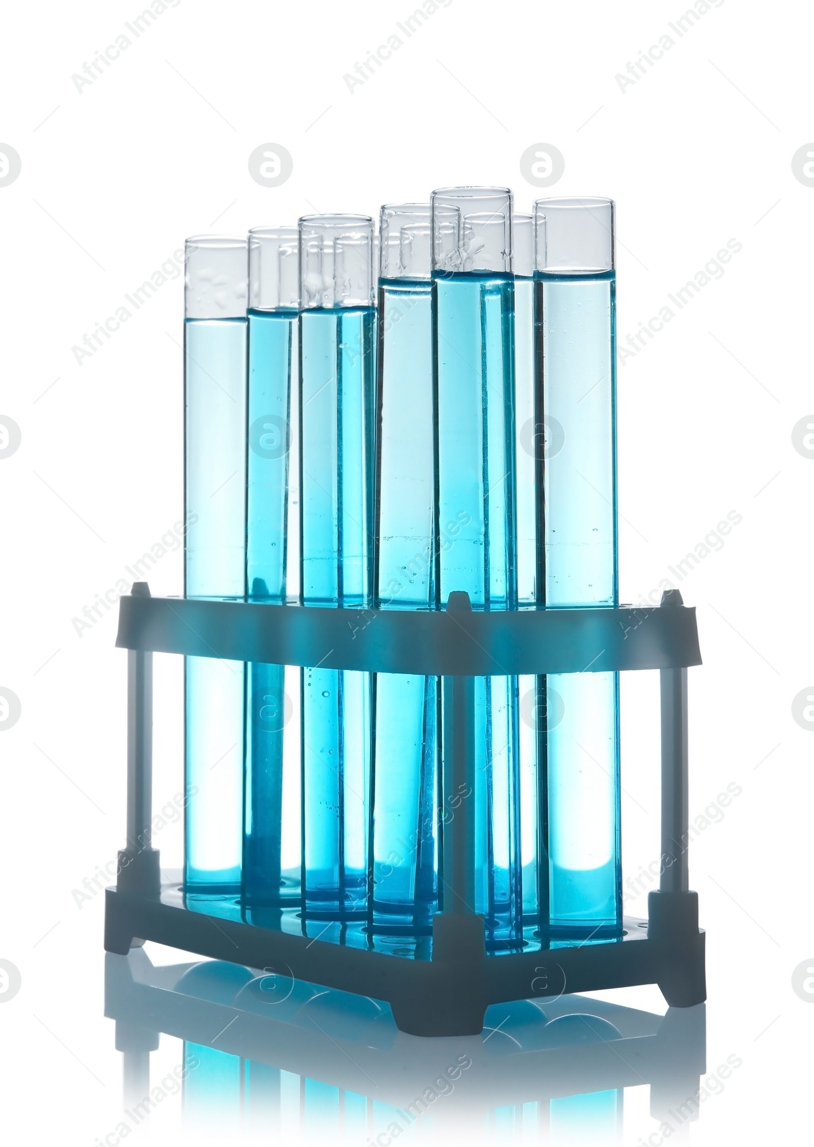 Photo of Test tubes with liquid in holder on table against white background. Laboratory analysis