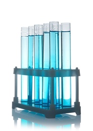 Photo of Test tubes with liquid in holder on table against white background. Laboratory analysis