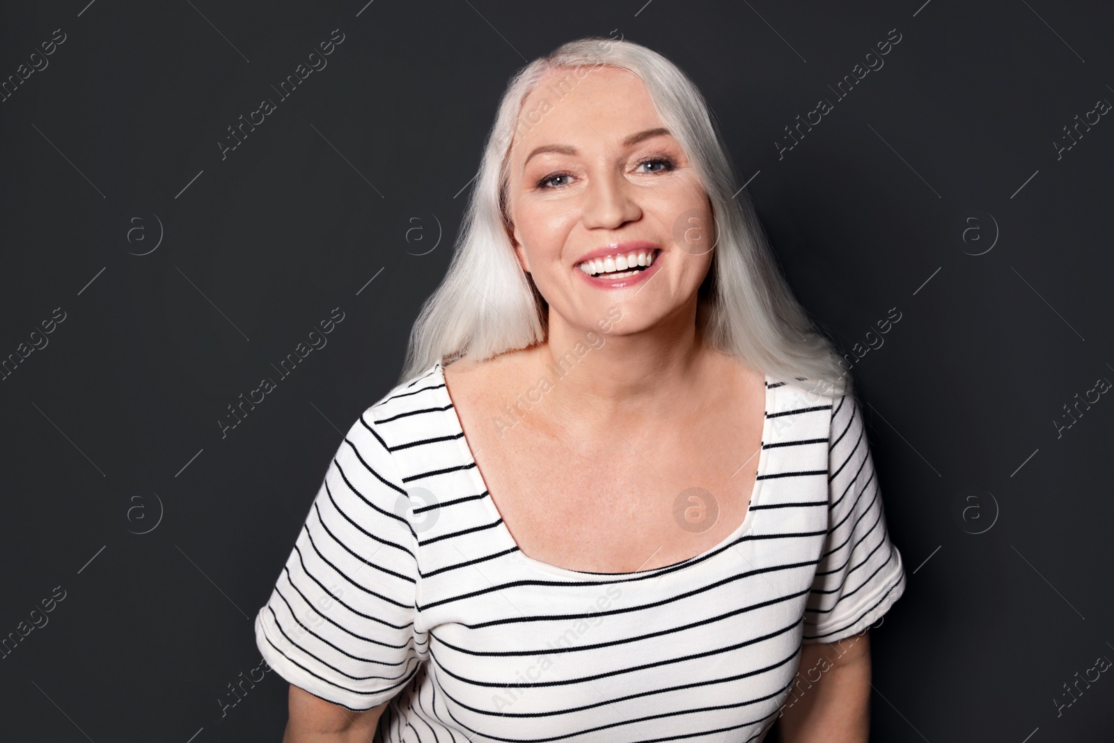 Photo of Portrait of mature woman on black background