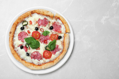 Photo of Delicious pizza Diablo on light marble background, top view. Space for text