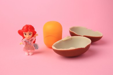 Photo of Slynchev Bryag, Bulgaria - May 25, 2023: Halves of Kinder Surprise Egg, plastic capsule and toy on pink background