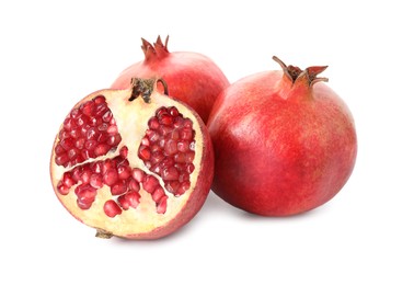 Photo of Half and whole pomegranates isolated on white