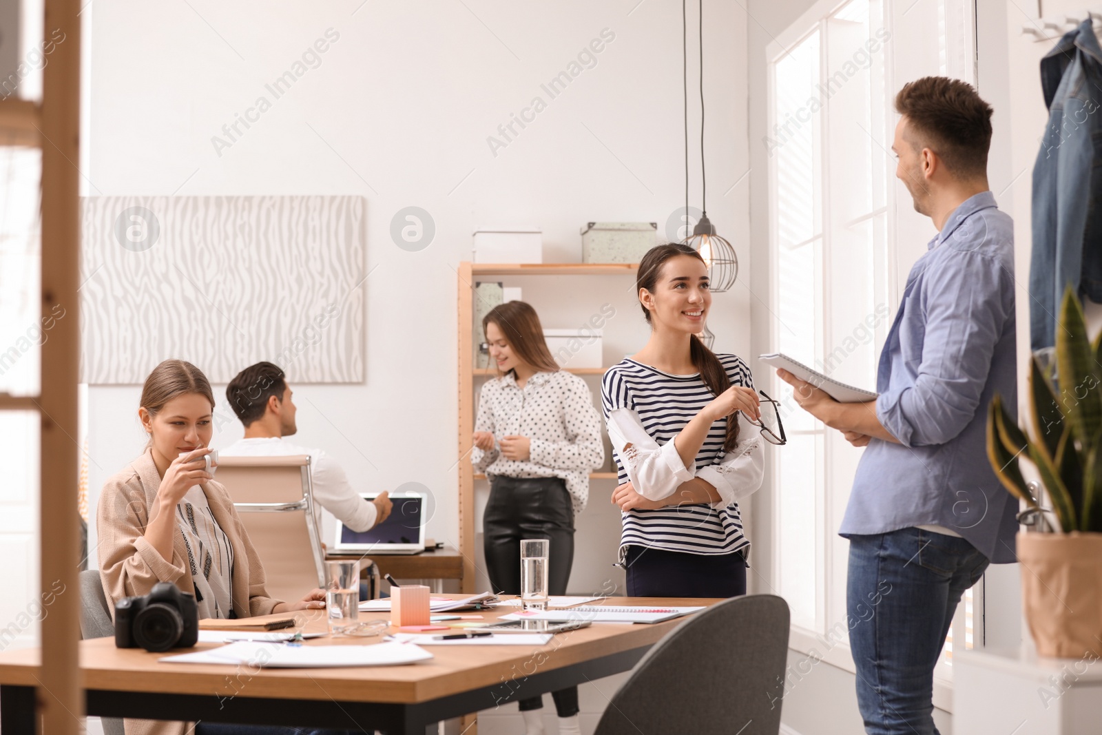 Photo of Team of professional journalists working in office