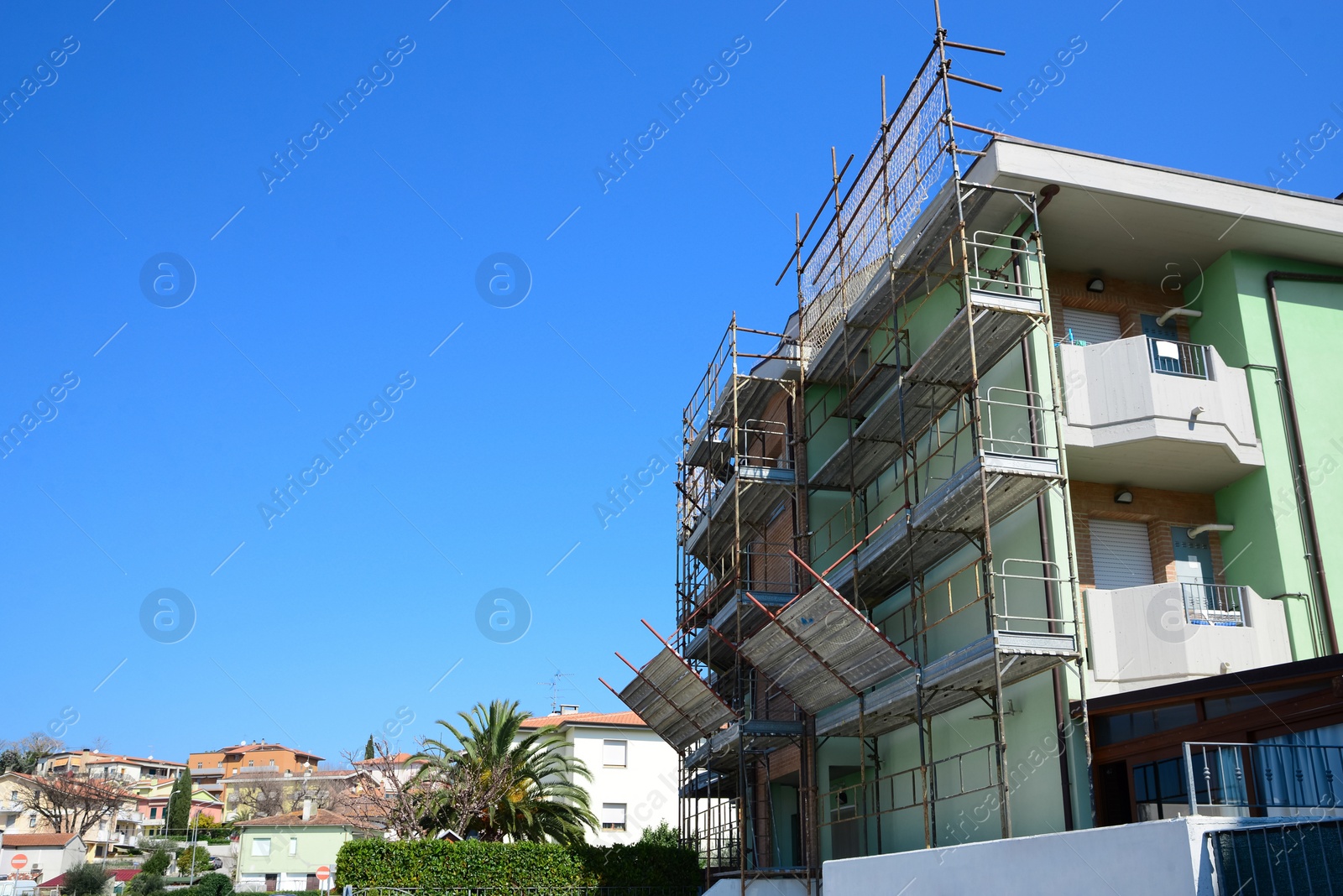 Photo of Cityscape with scaffolding near modern building on sunny day