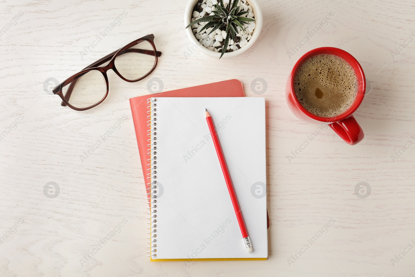 Photo of Flat lay composition with office stationery and cup of coffee on white wooden table