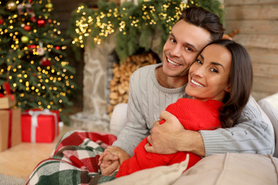 Happy young couple in living room decorated for Christmas