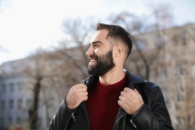 Portrait of happy young man outdoors on sunny day