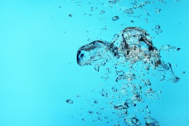 Image of Many air bubbles in water on light blue background, space for text