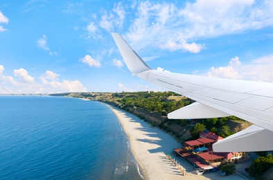 Airplane landing on tropical island, view from porthole