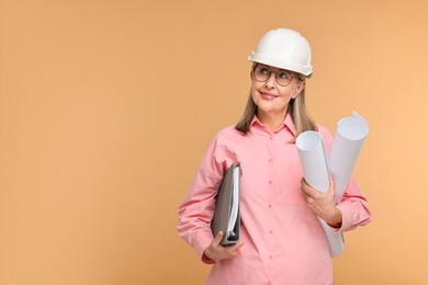 Architect in hard hat with drafts and folder on beige background, space for text