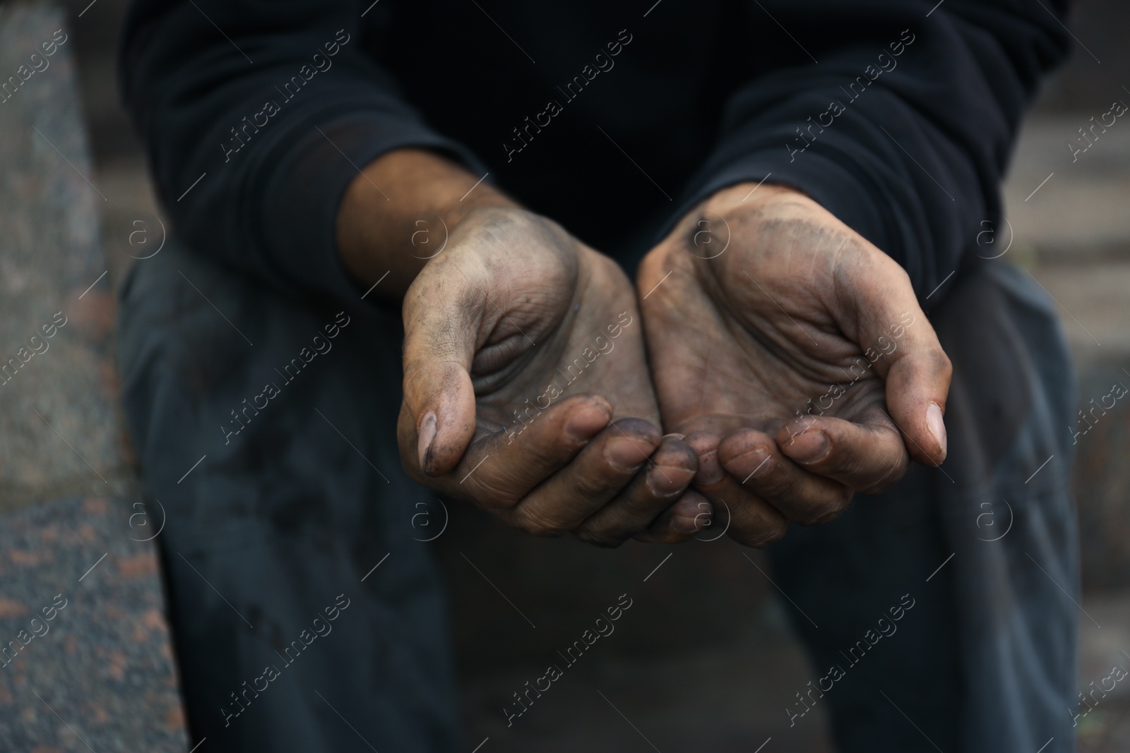 Photo of Poor homeless man begging for help outdoors, closeup