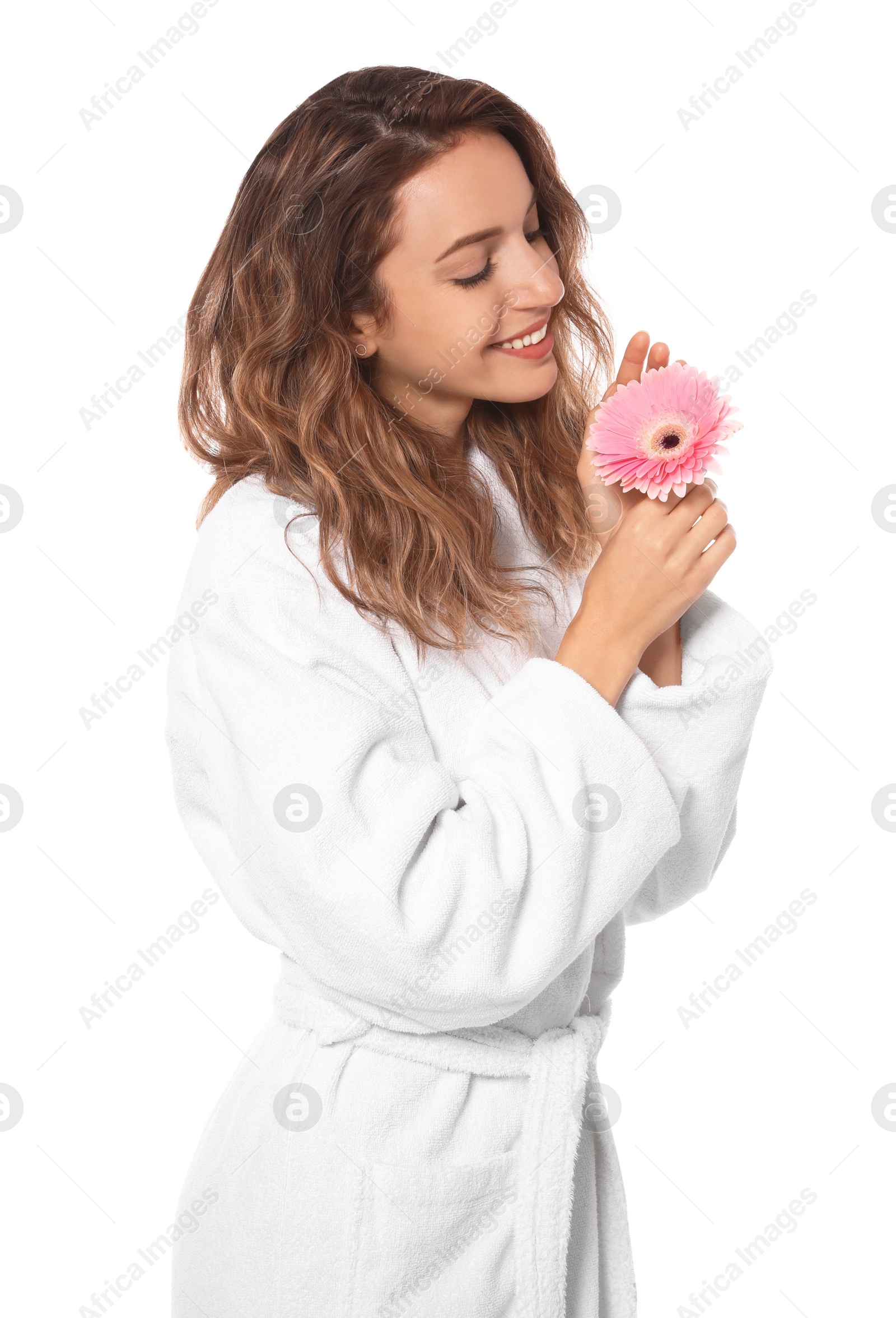 Photo of Beautiful young woman with flower wearing bathrobe on white background