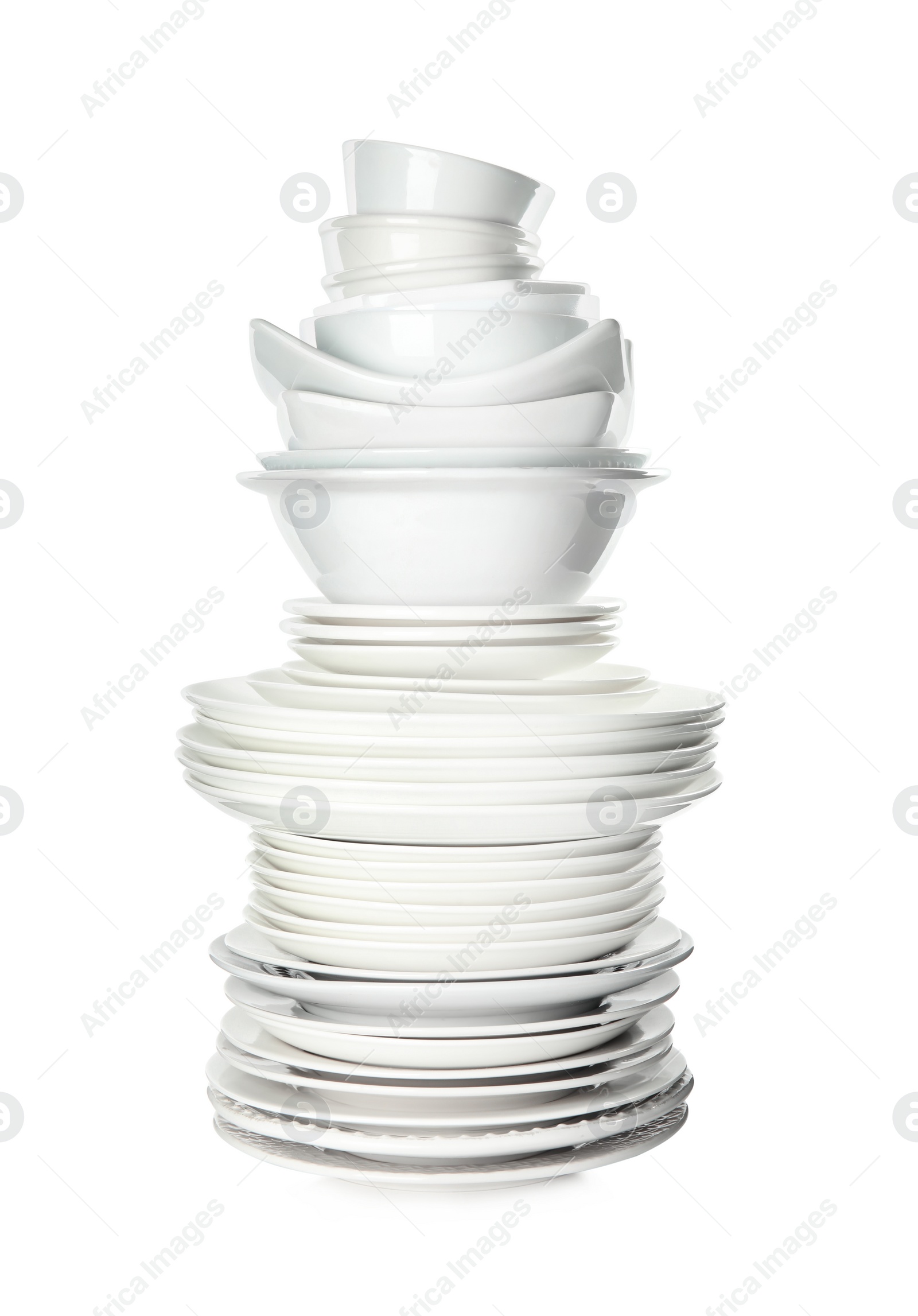 Photo of Stack of clean tableware isolated on white