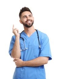 Photo of Young male doctor in uniform isolated on white