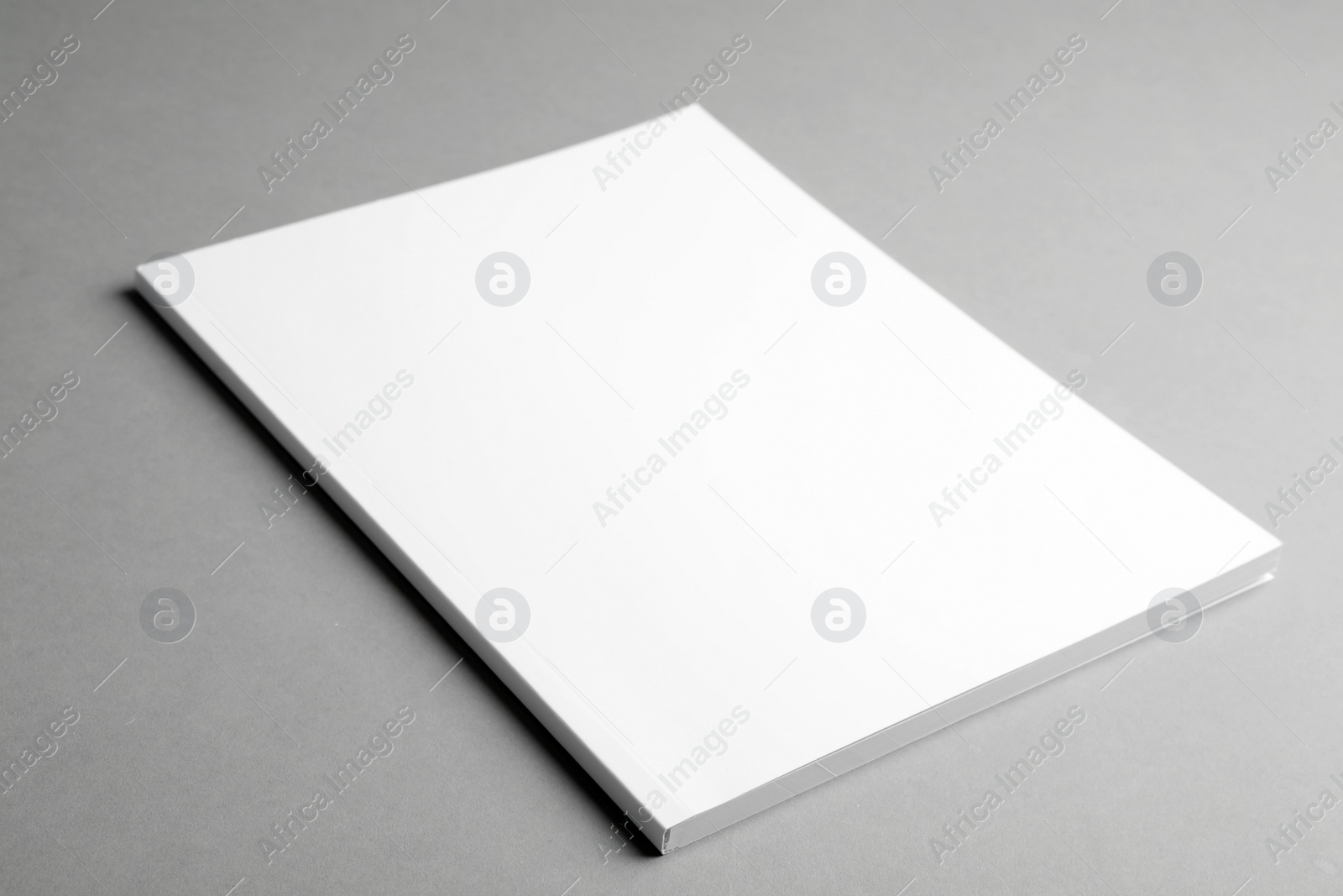 Photo of Brochure with blank cover on grey background. Mock up for design