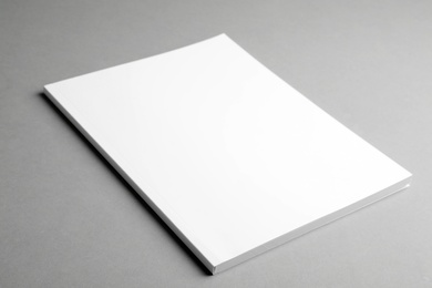 Photo of Brochure with blank cover on grey background. Mock up for design