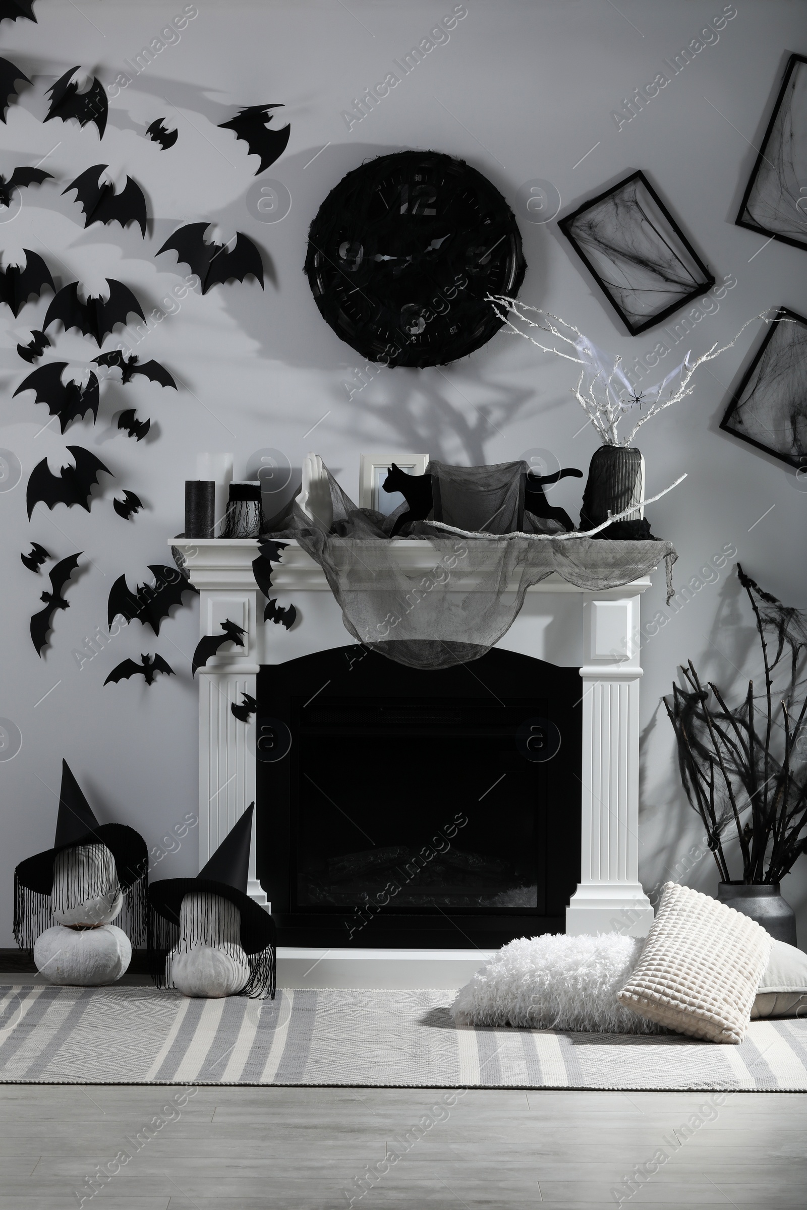 Photo of Stylish room with fireplace decorated for Halloween