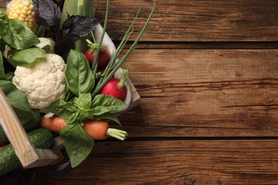 Photo of Many different vegetables on wooden table, top view. Space for text