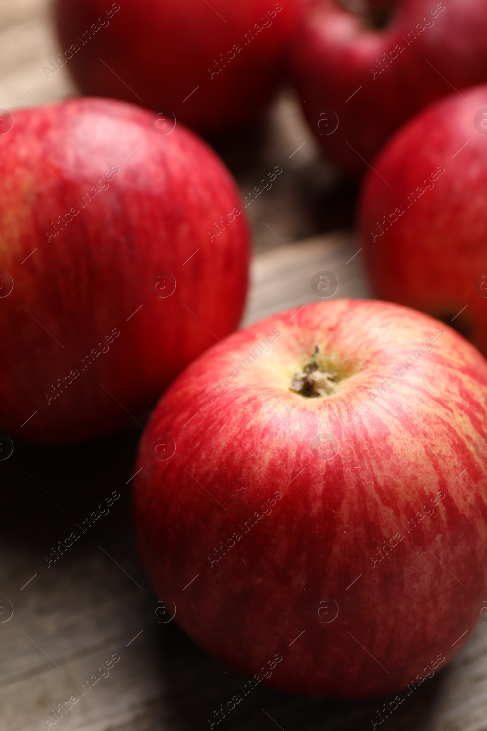 Photo of Fresh red apples on wooden table, closeup