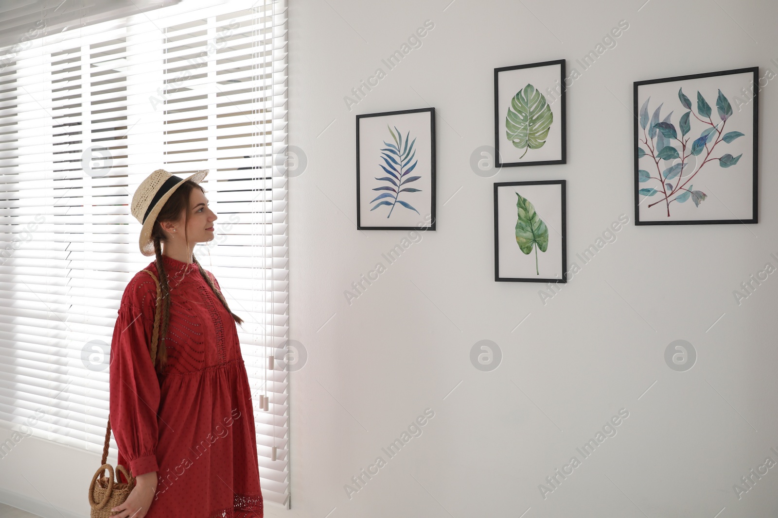 Photo of Young woman at exhibition in art gallery