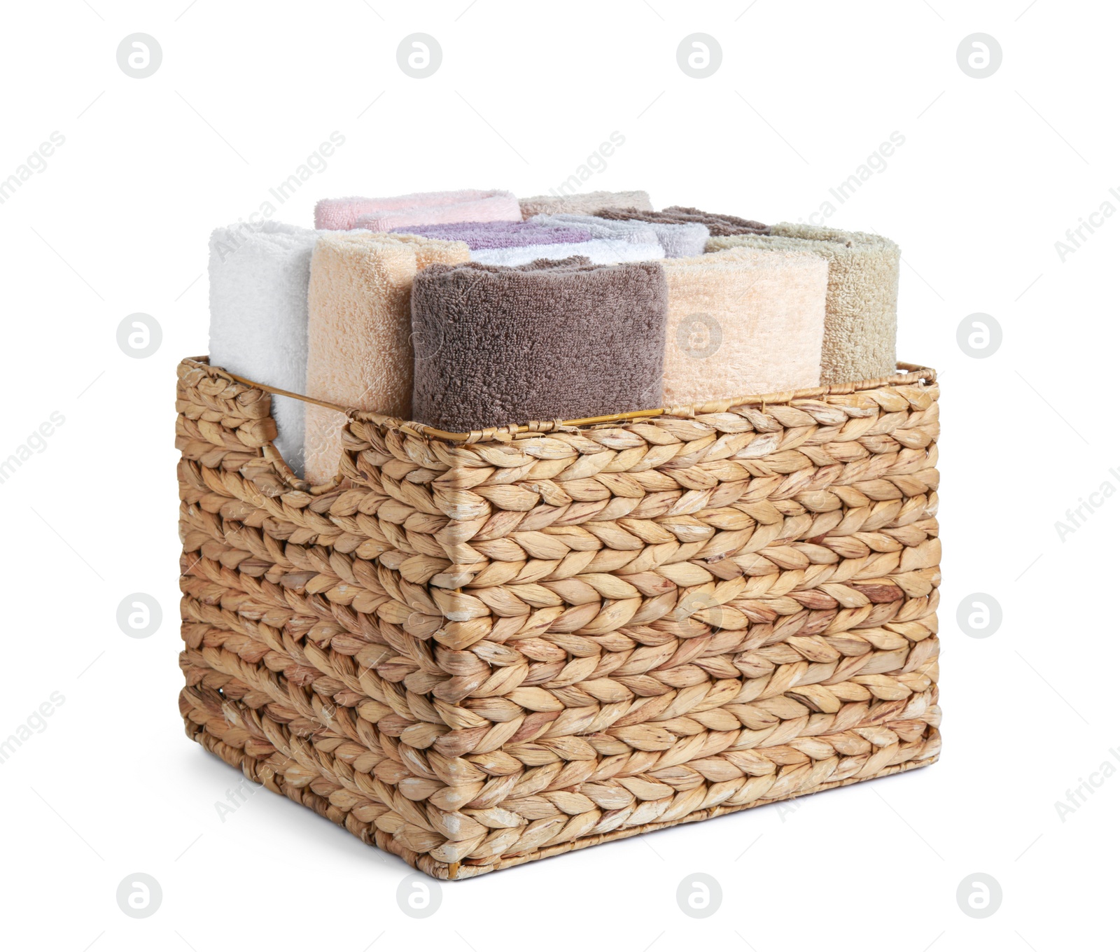 Photo of Wicker laundry basket with clean terry towels isolated on white