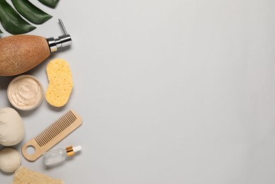 Bath accessories. Flat lay composition with personal care products on light grey background, space for text