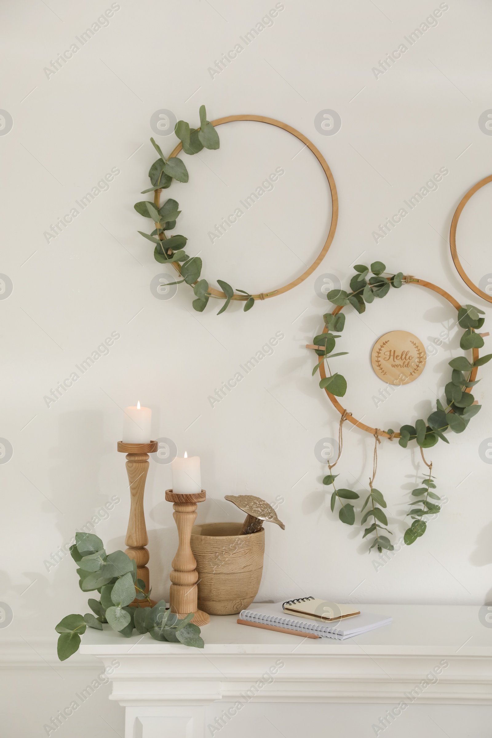 Photo of Beautiful eucalyptus decor on white wall in room. Interior element