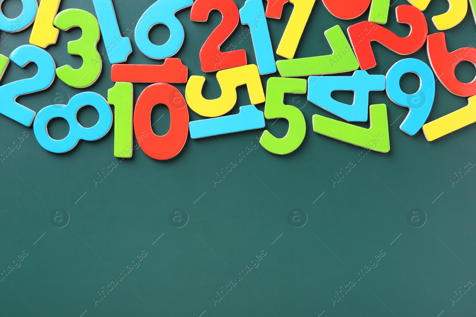 Photo of Colorful numbers on green background, flat lay. Space for text